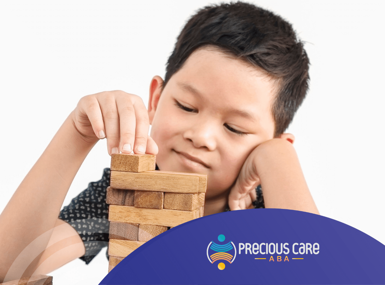 A boy with autism playing Jenga