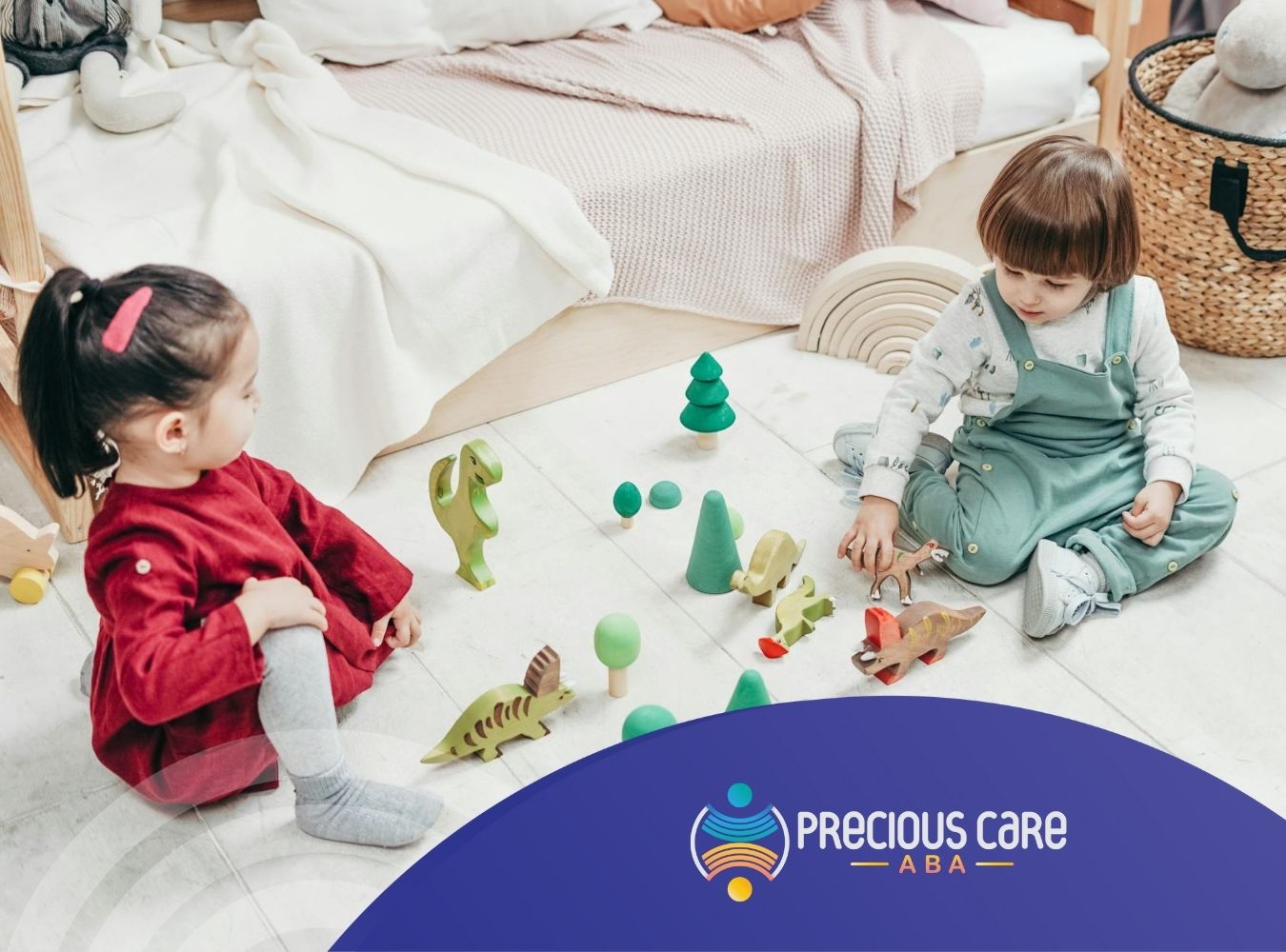 Two autistic children sit on the floor, playing with dinosaur and tree toys at a bedroom in MD.