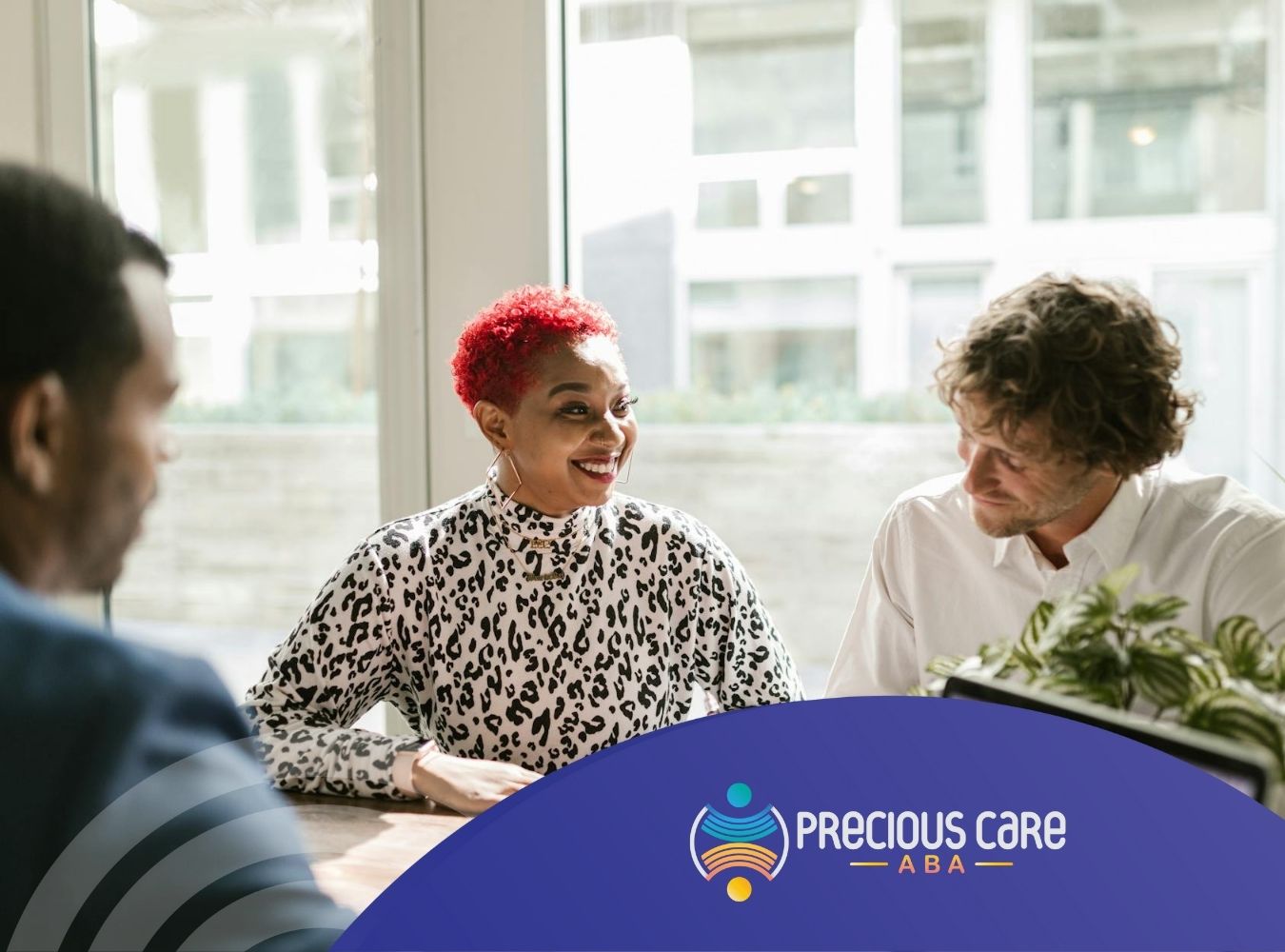 Parents and agents discussing insurance paperwork for ABA therapy at an office table in Maryland.