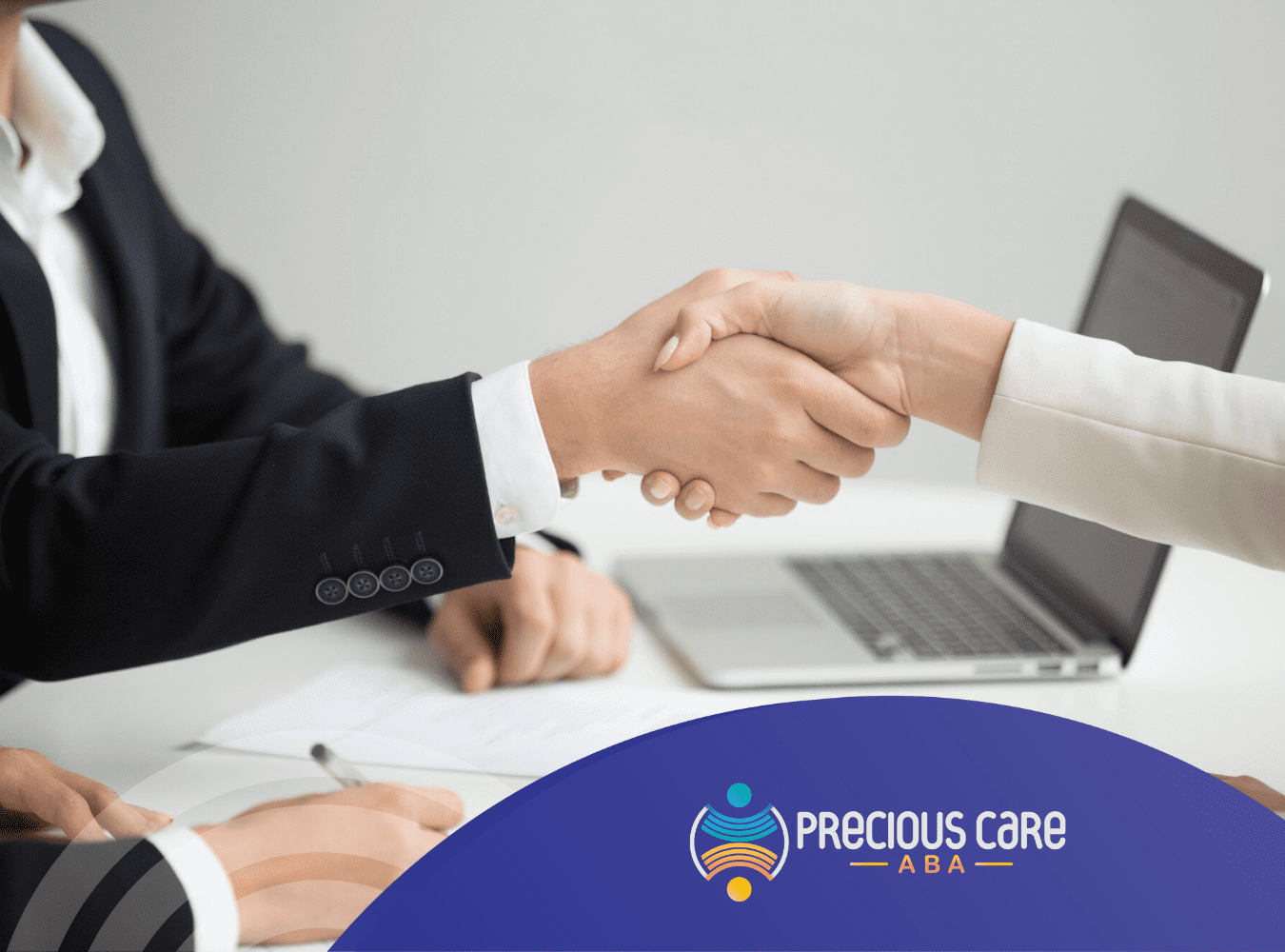 An adult with autism is shaking hands with an employer