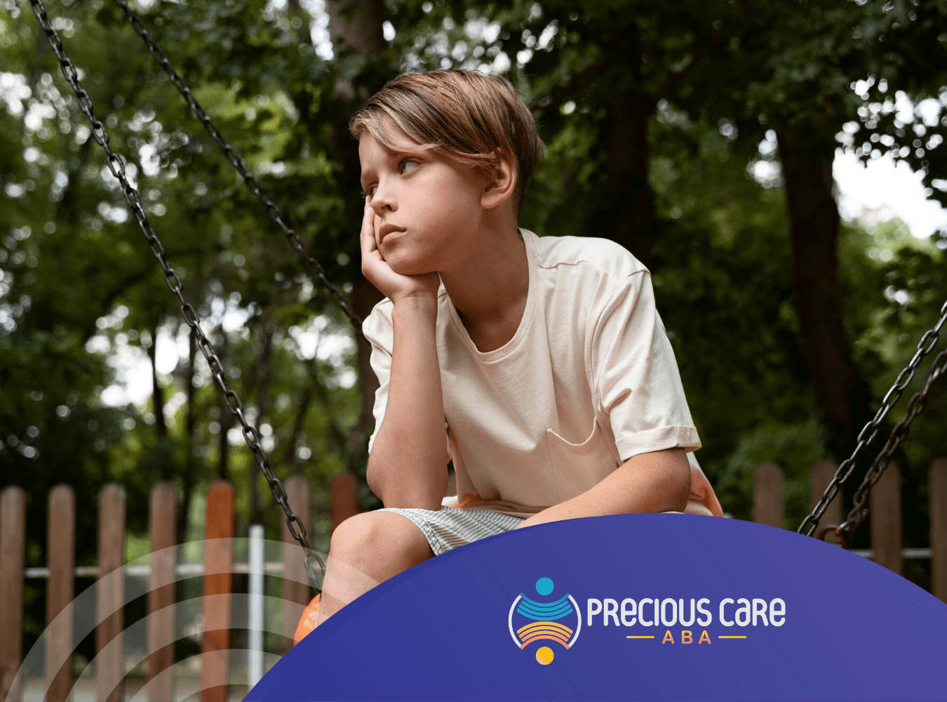 A boy with autism is sitting alone in a park