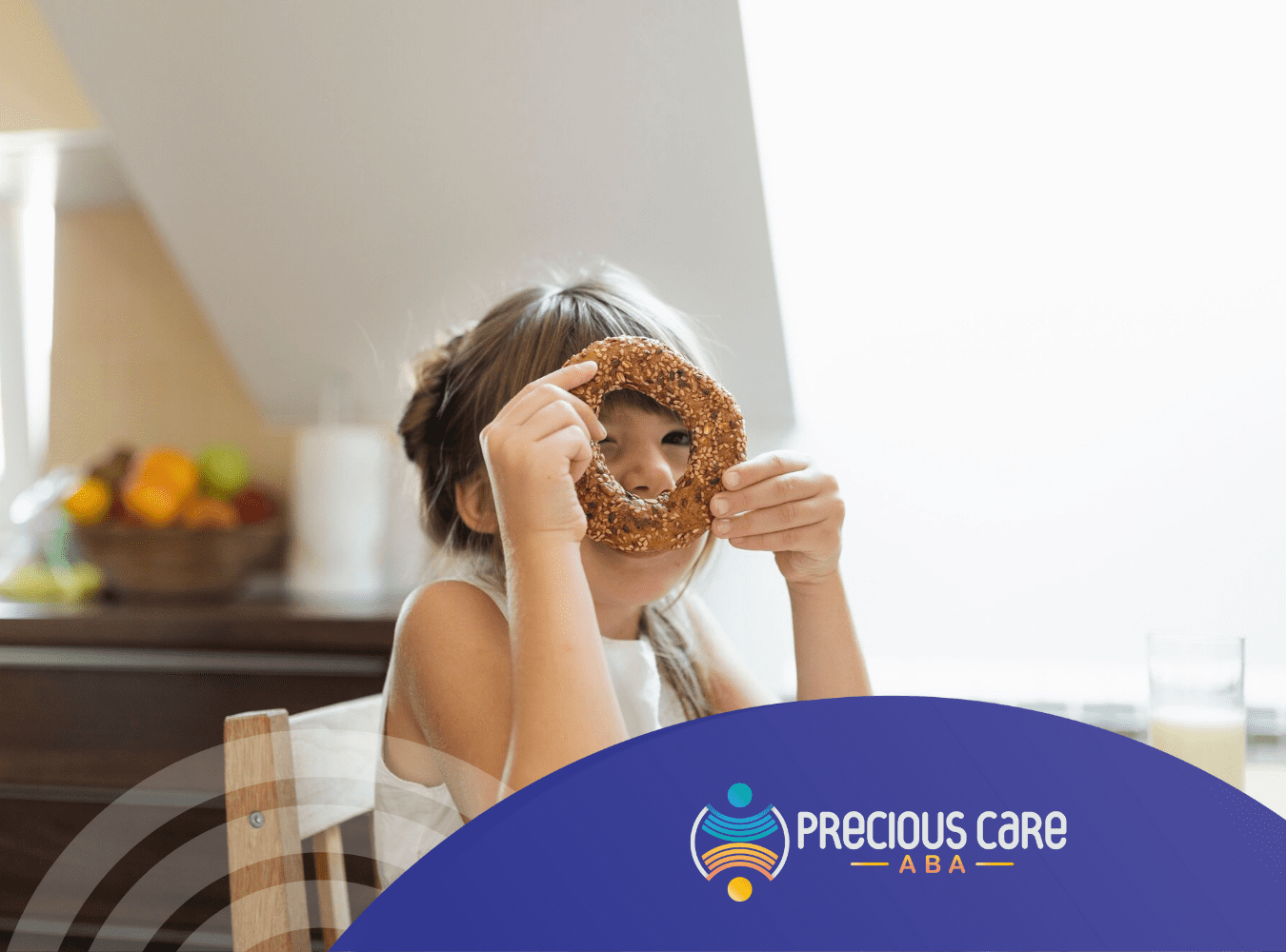 A girl with autism is holdin a bagel on her face