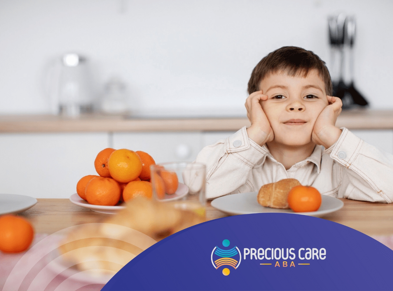 An autistic boy is sitting on a table with oranges