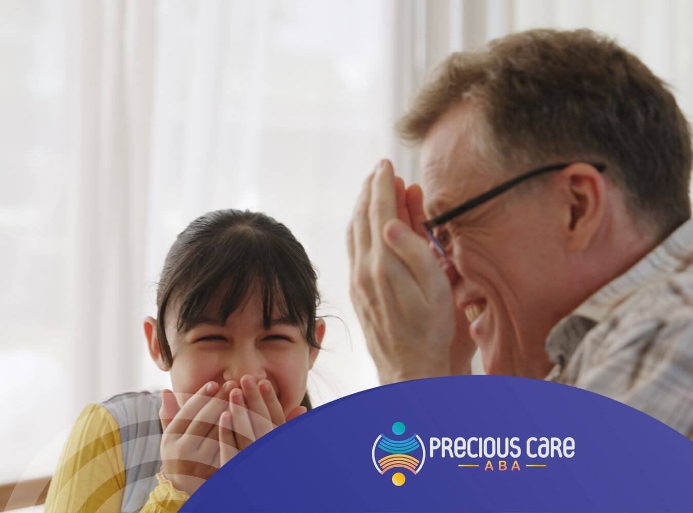 Autistic girl and her grandfather laughing and covering their faces after ABA therapy.