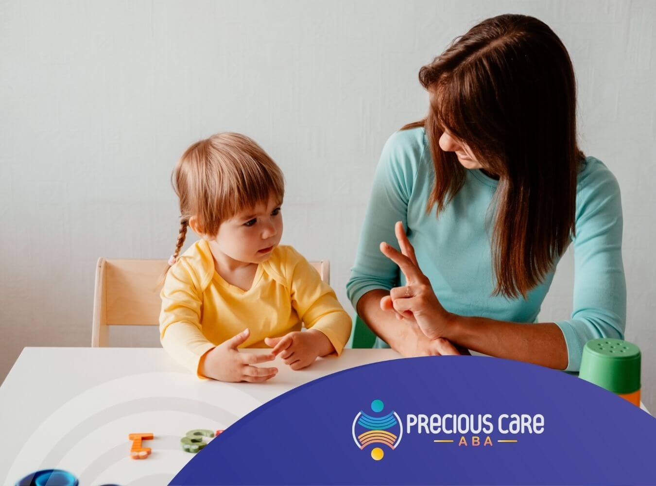 BCBA teaching autistic toddler using colorful number magnets and hand gestures in ABA therapy.