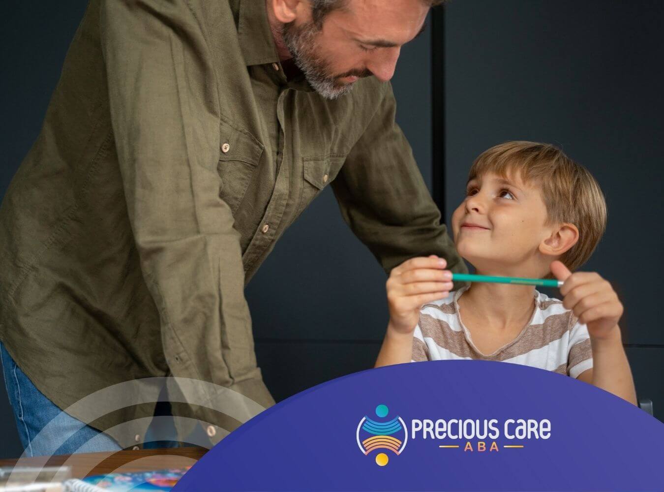 ABA therapist engaging warmly with young boy during ABA therapy session.