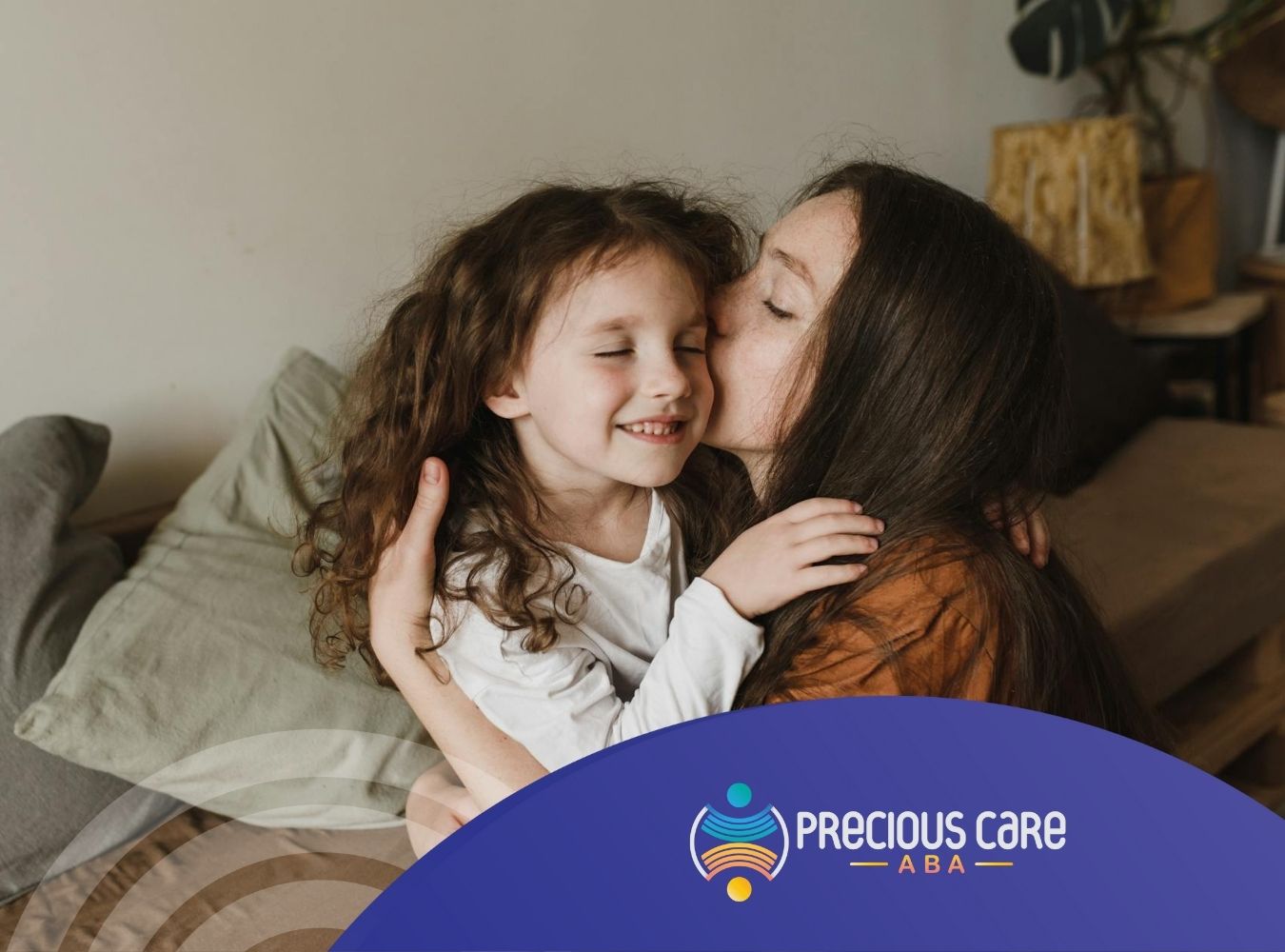 A mother and her autistic child sharing a loving embrace, both smiling warmly during ABA therapy in Maryland.